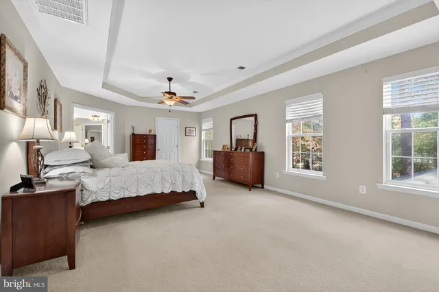 a backyard of a house with fountain and outdoor seating