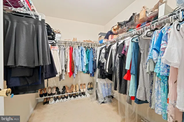 a front view of a house with a yard and lake view