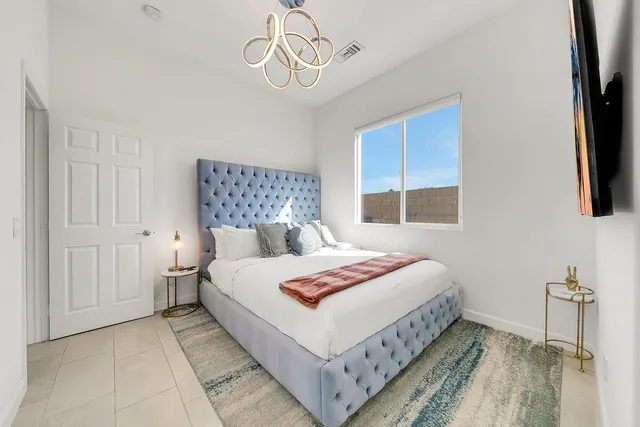 a bedroom with a bed and a flat screen tv