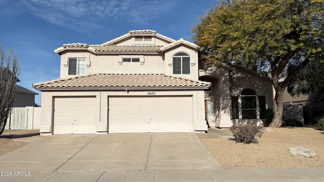 a front view of a house with a yard and garage