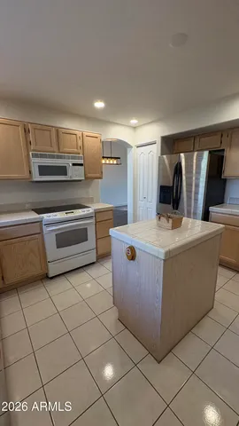 an empty room with closet and a ceiling fan