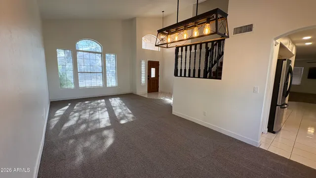 a kitchen with stainless steel appliances a sink and white cabinets
