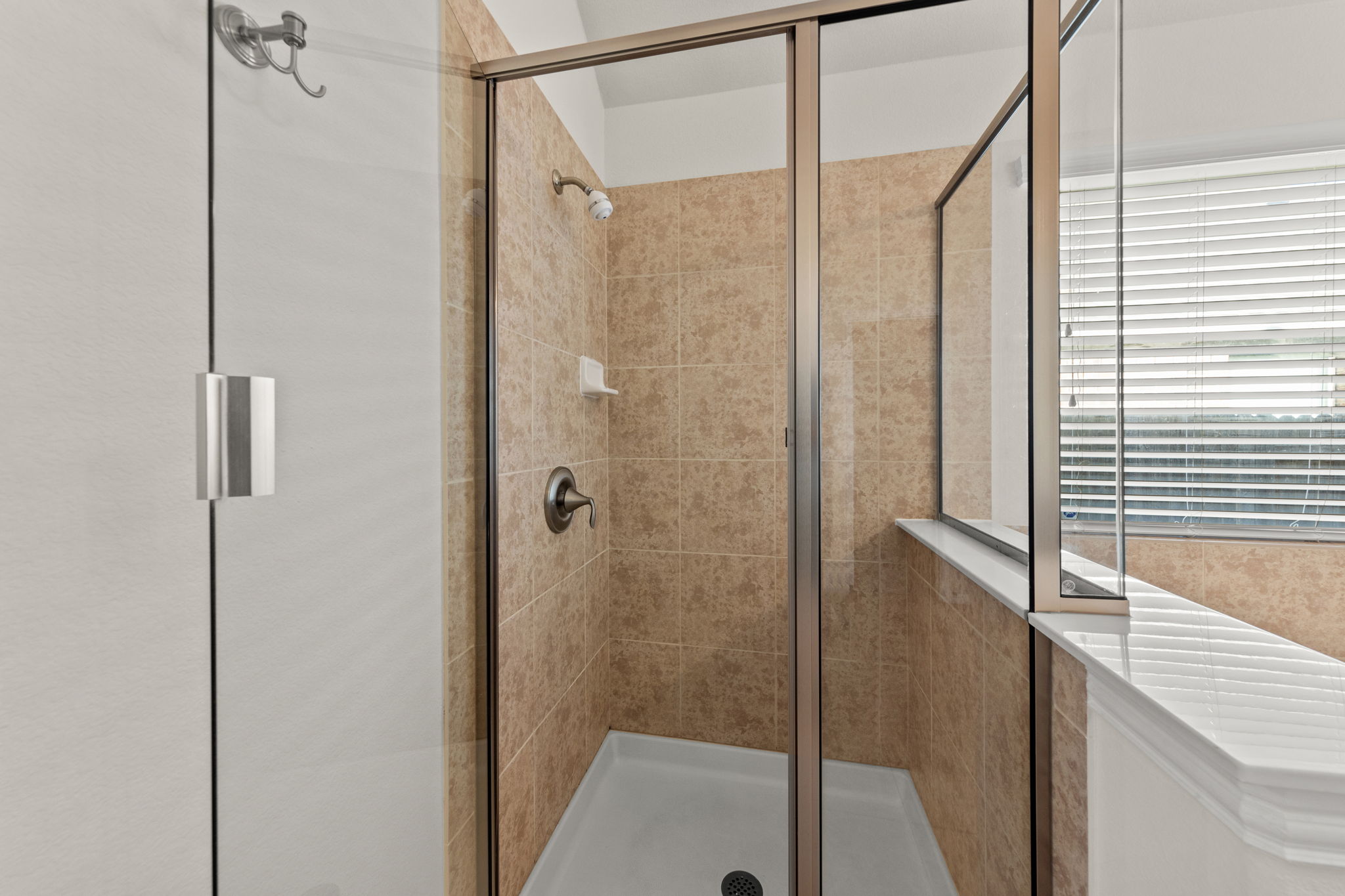 411 Tascate Street Georgetown, TX 78628 - Photo 24 of 41 A well-appointed shower stall features tiled walls and a functional glass enclosure.