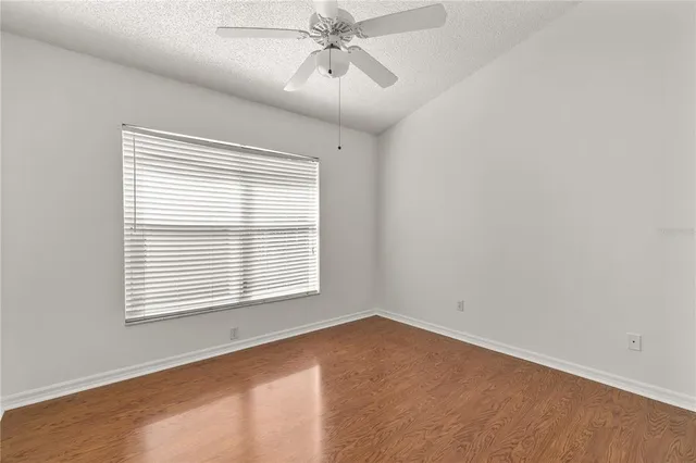 a view of an ocean with a big yard and large trees