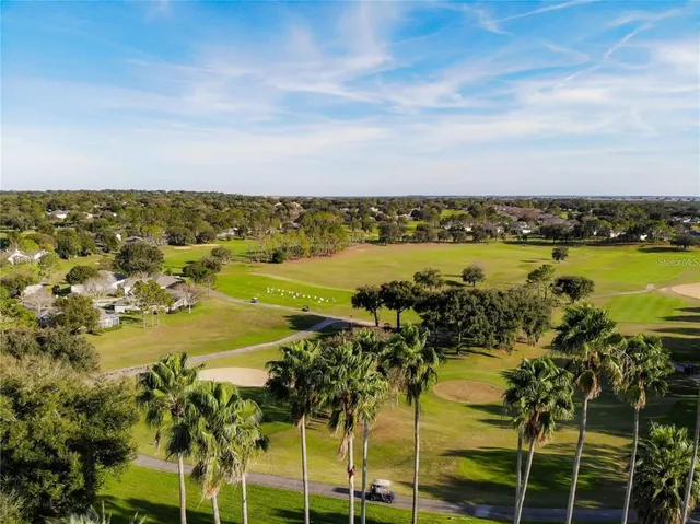 an aerial view of a house with yard and stairs