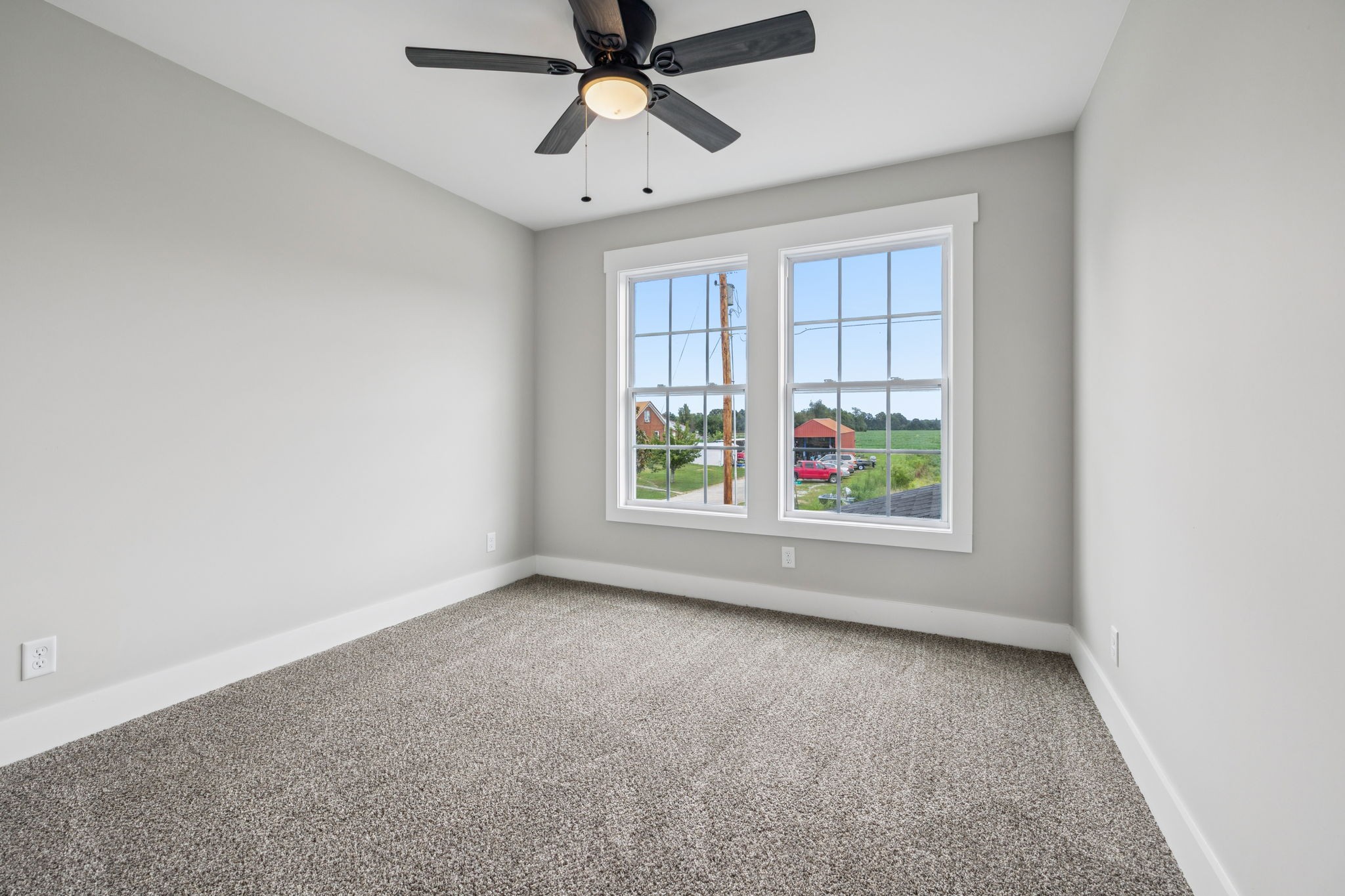 700 Robinson Road Smithville, TN 37166 - Photo 28 of 36 an empty room with windows and chandelier fan