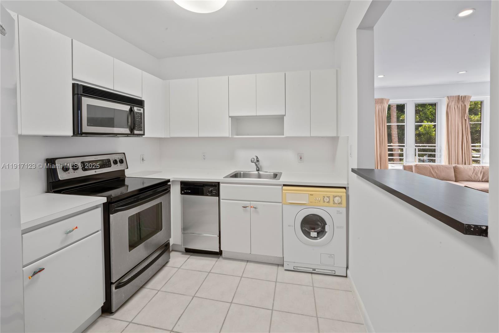 1018 Meridian Avenue, Unit 5 Miami Beach, FL 33139 - Photo 11 of 18 a kitchen with a stove microwave and sink