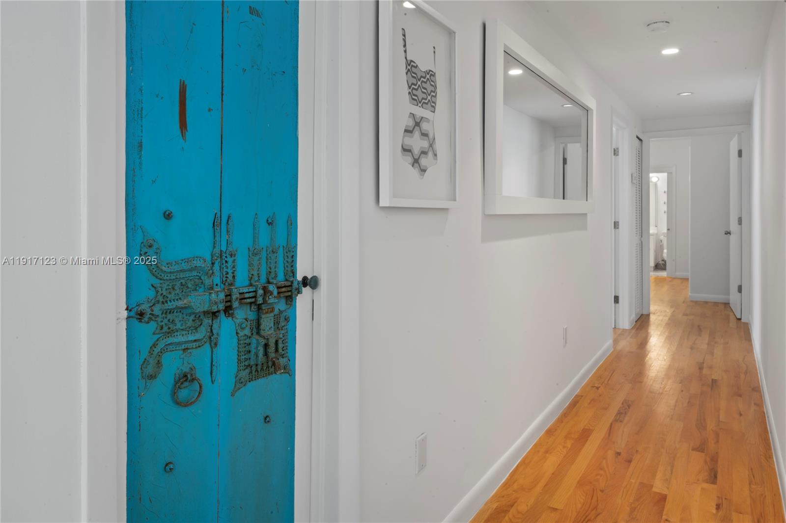 1018 Meridian Avenue, Unit 5 Miami Beach, FL 33139 - Photo 12 of 18 a view of a hallway with wooden floor and staircase