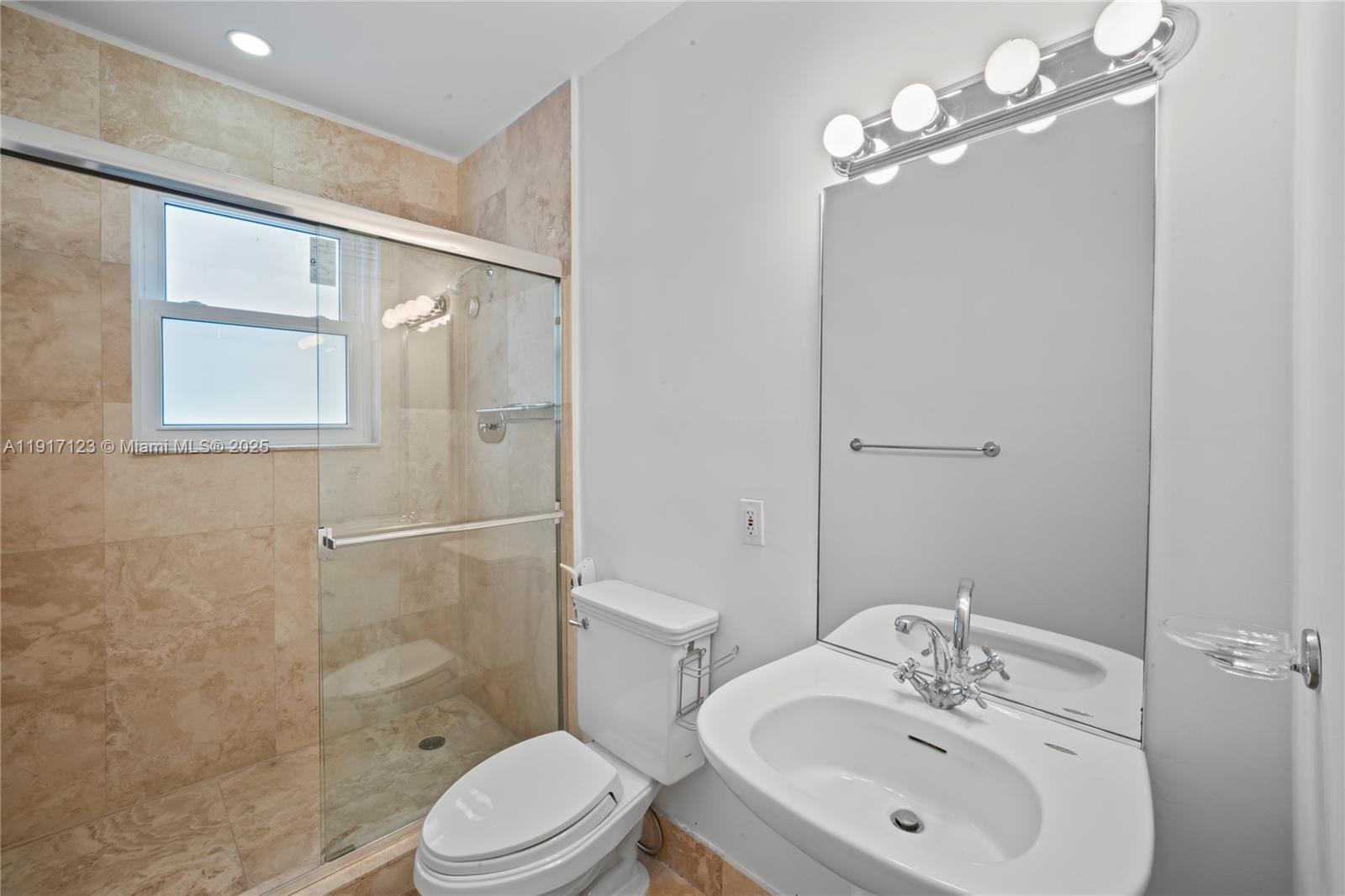 1018 Meridian Avenue, Unit 5 Miami Beach, FL 33139 - Photo 13 of 18 a bathroom with a sink a toilet and shower