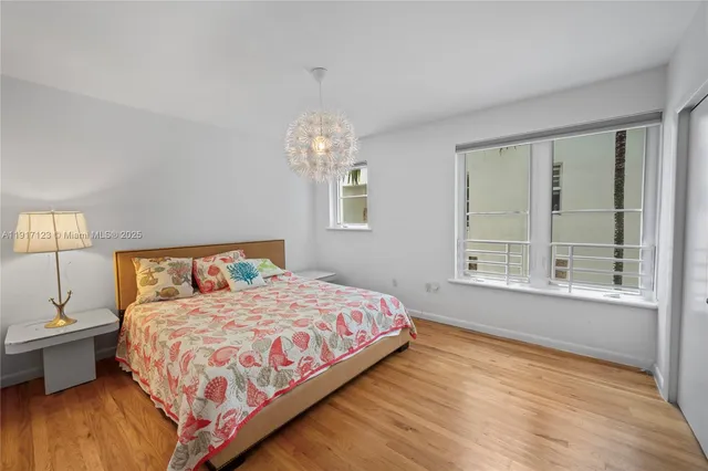 a bedroom with a large bed and a large window