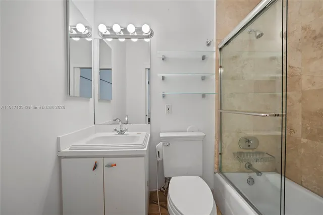 a bathroom with a sink toilet tub and shower