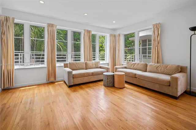 a living room with furniture and windows