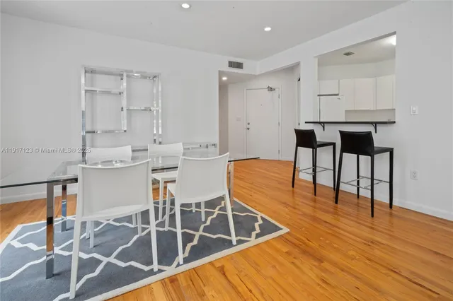 a view of kitchen and dining area with wooden floor