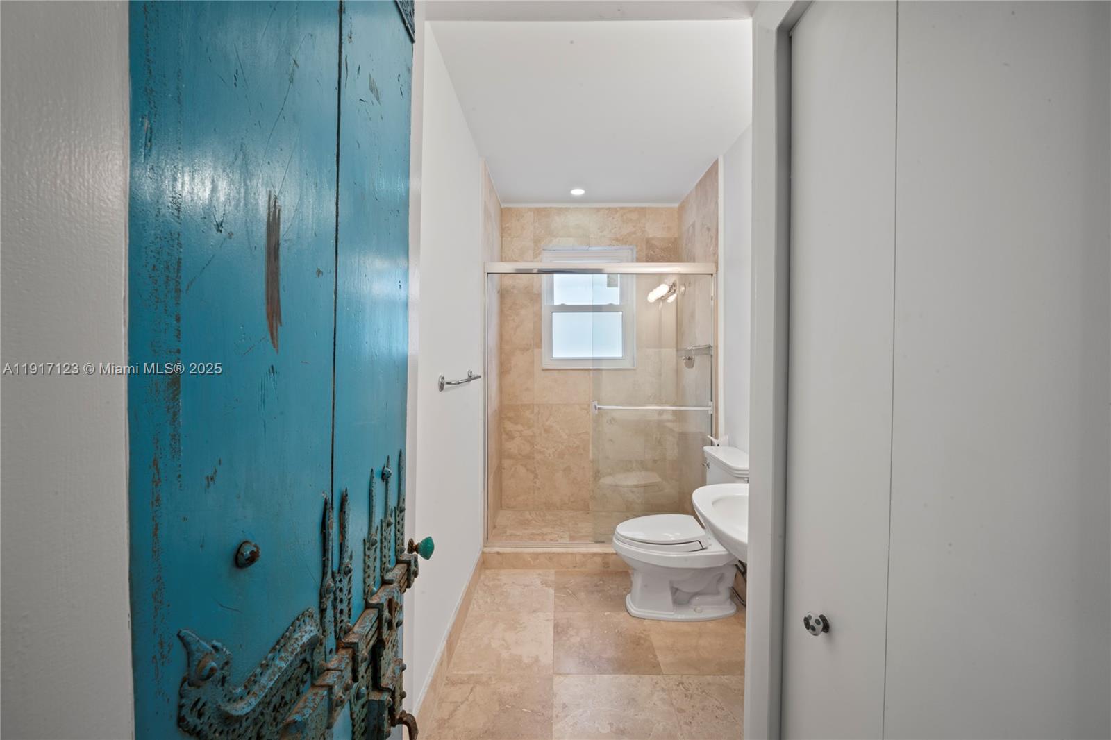 1018 Meridian Avenue, Unit 5 Miami Beach, FL 33139 - Photo 10 of 18 a bathroom with a glass shower door and a toilet