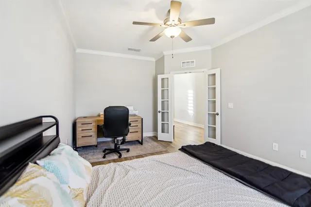 a bedroom with a bed a desk and chair