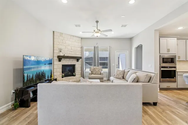 a living room with furniture fireplace and flat screen tv