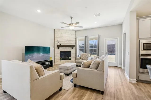 a living room with furniture fireplace and a flat screen tv