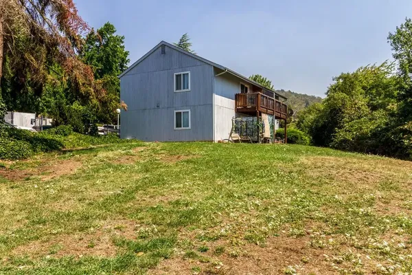a house that has a tree in front of it