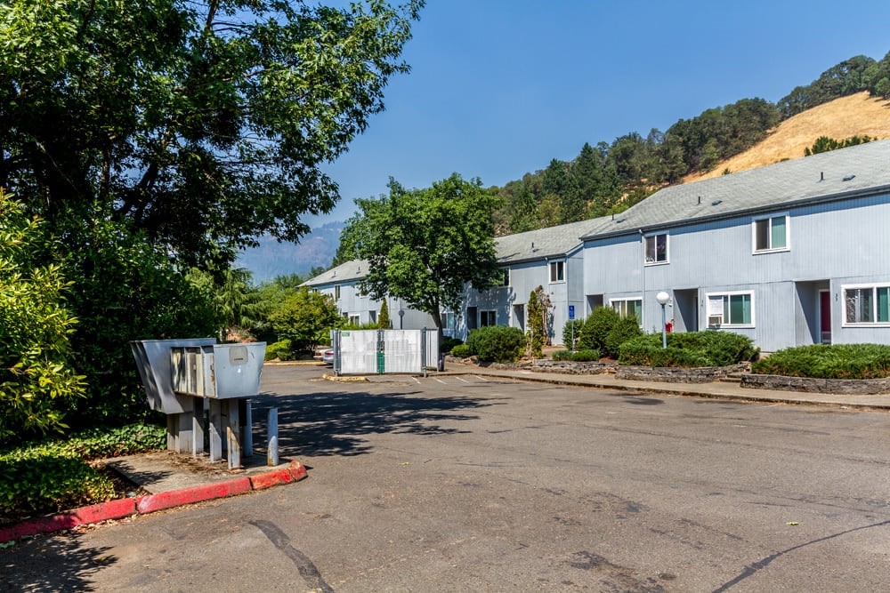 721 Southeast Meadowlark Avenue Myrtle Creek, OR 97457 - Photo 8 of 10 a view of a patio with table and chairs plants and palm trees