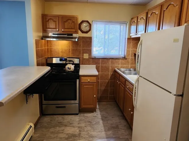 a kitchen with a refrigerator and a stove