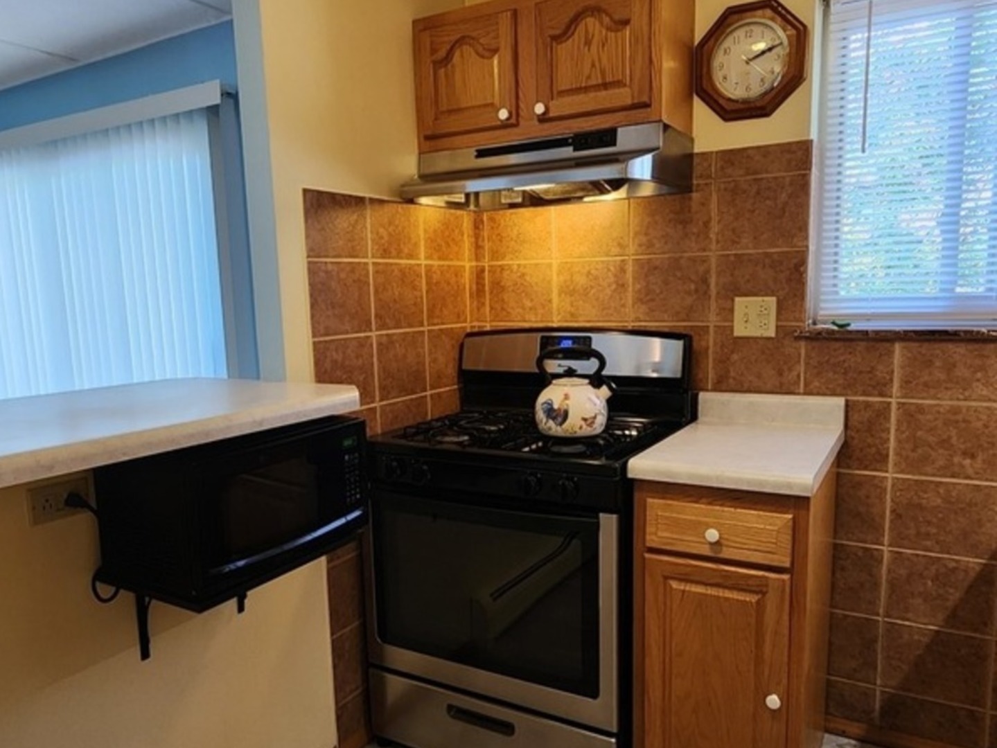 588 Fairway View Drive, Unit 2E Wheeling, IL 60090 - Photo 6 of 13 a kitchen with a stove and a microwave