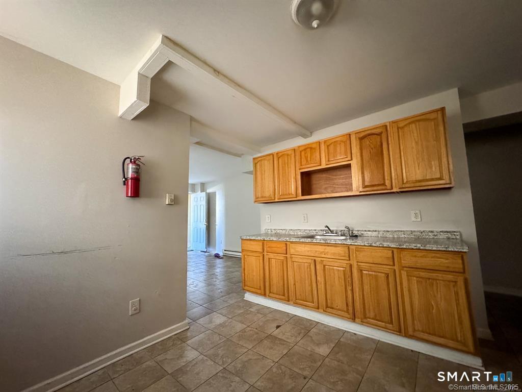 40 Jane Street Bridgeport, CT 06608 - Photo 15 of 30 a room with stainless steel appliances wooden cabinets and a sink