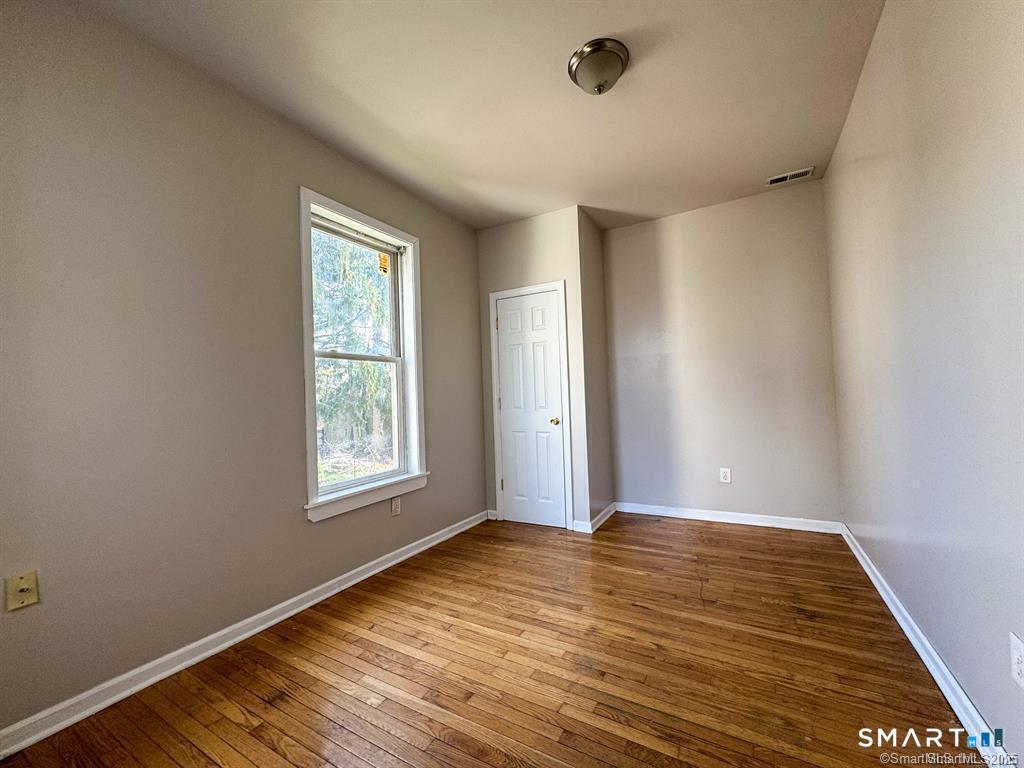 40 Jane Street Bridgeport, CT 06608 - Photo 20 of 30 a view of an empty room with wooden floor and a window