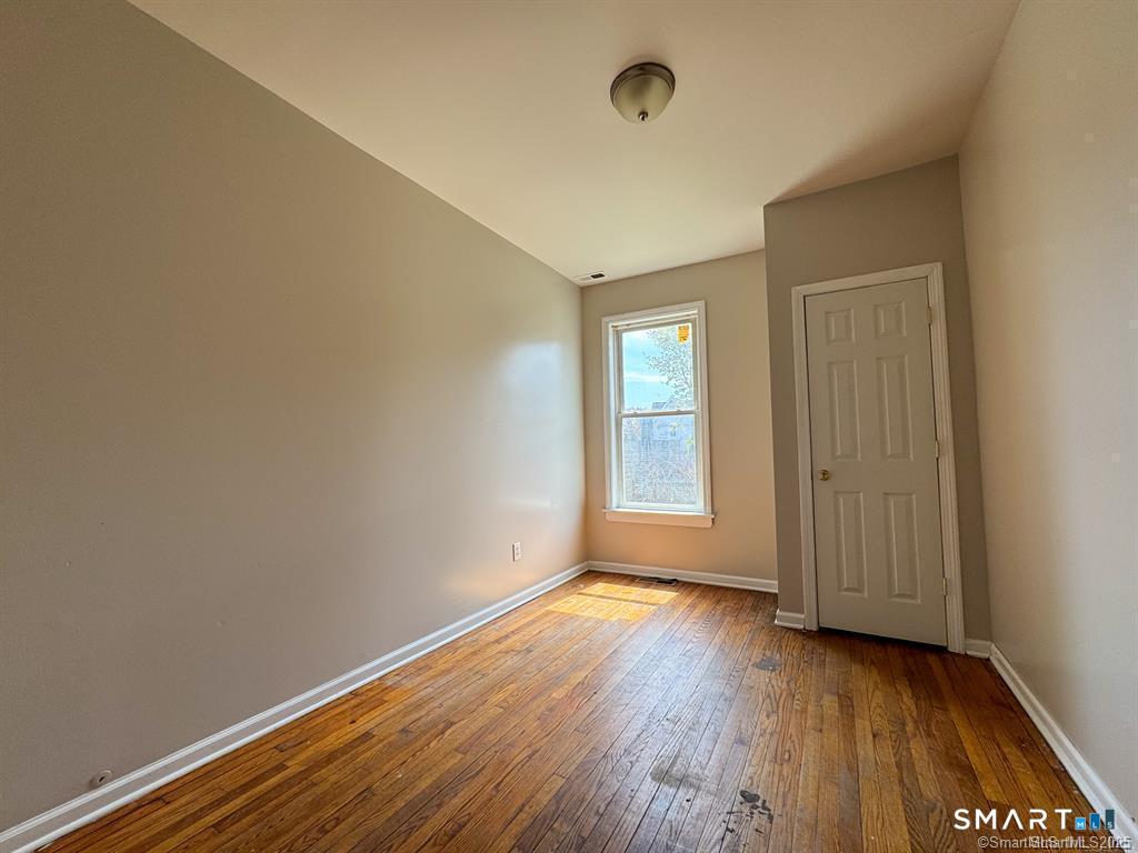 40 Jane Street Bridgeport, CT 06608 - Photo 22 of 30 an empty room with wooden floor and windows