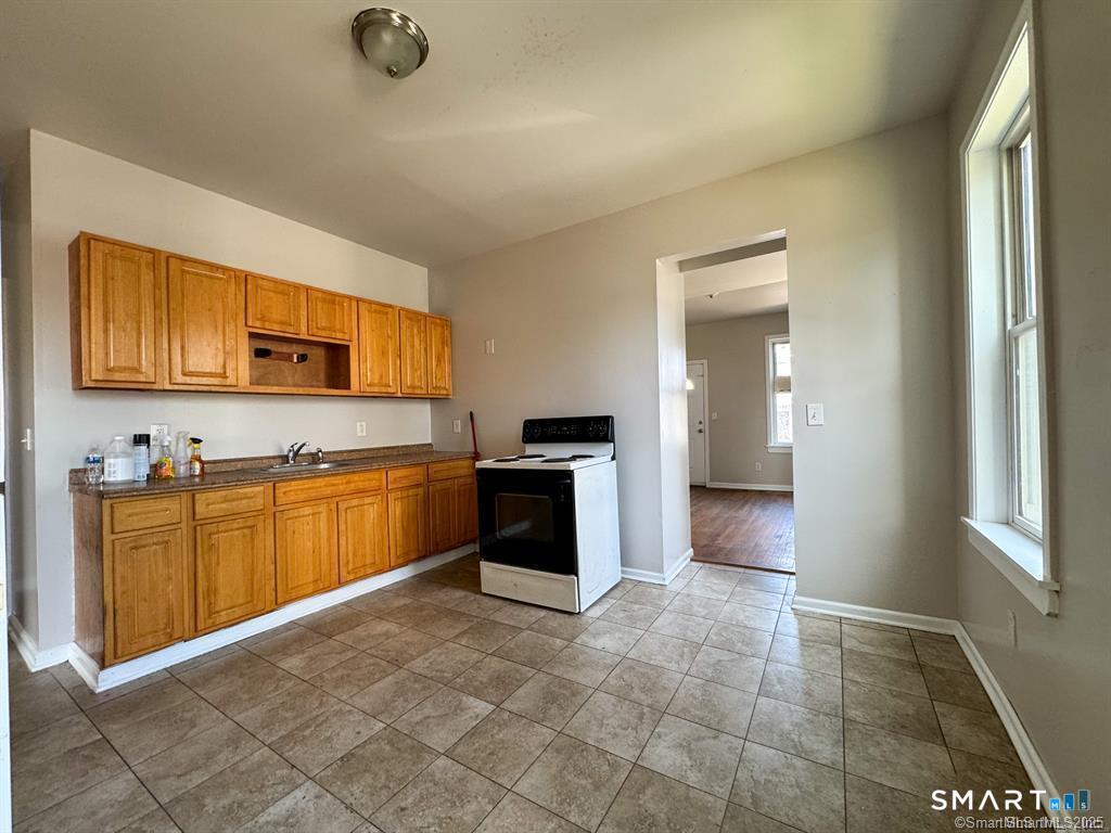 40 Jane Street Bridgeport, CT 06608 - Photo 25 of 30 a large kitchen with stainless steel appliances granite countertop a stove a sink and a refrigerator