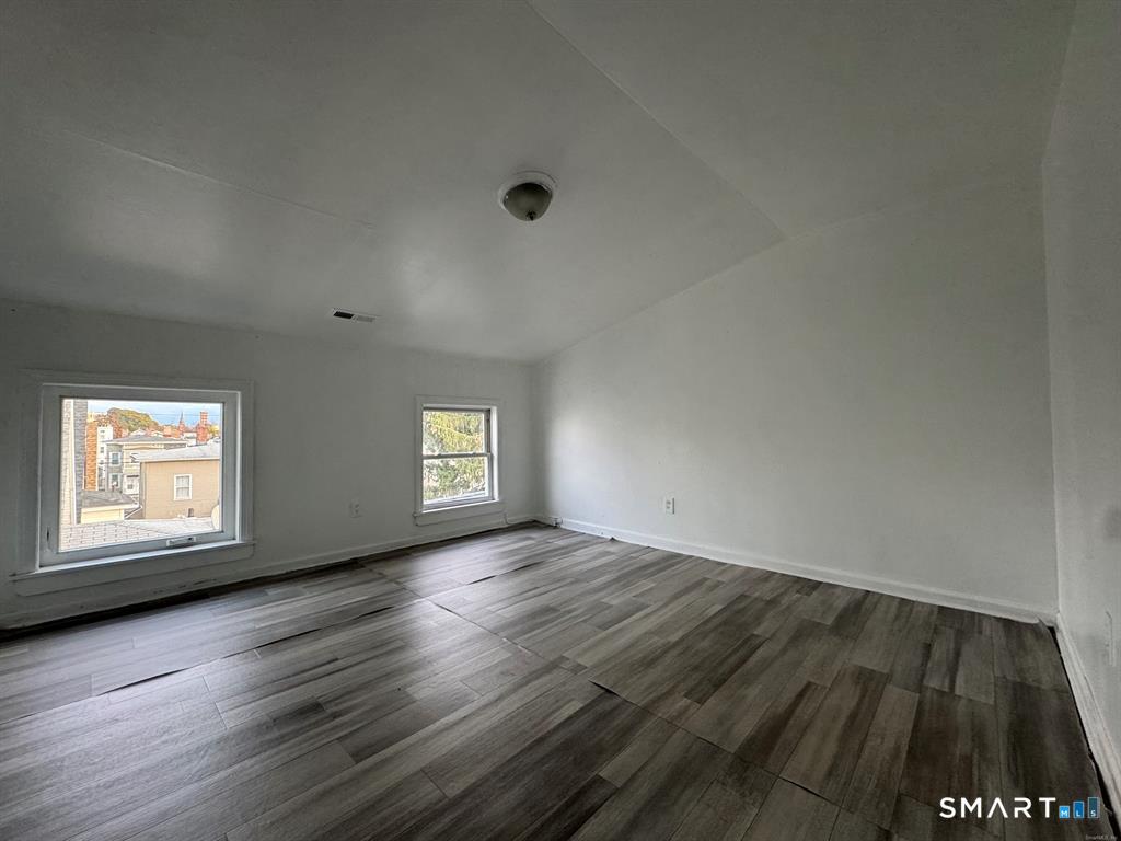 40 Jane Street Bridgeport, CT 06608 - Photo 27 of 30 an empty room with wooden floor and windows