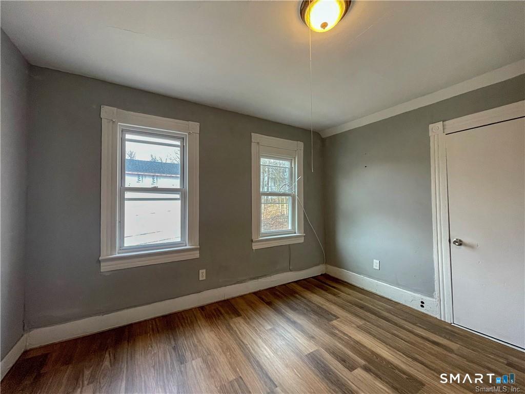 40 Jane Street Bridgeport, CT 06608 - Photo 30 of 30 an empty room with wooden floor and windows