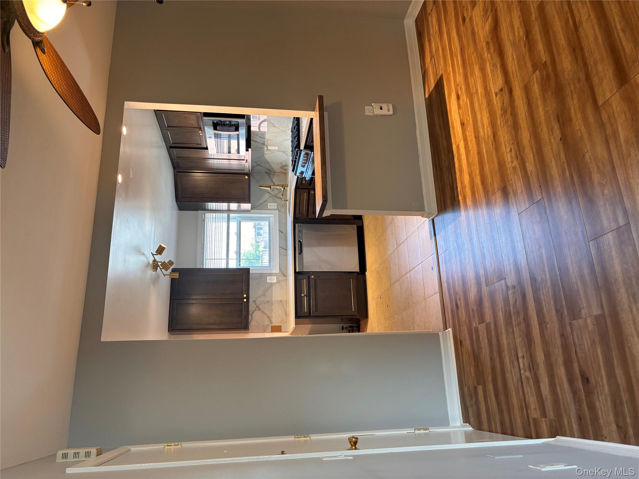 60-33 60th Street Queens, NY 11378 - Photo 1 of 1 a kitchen with stainless steel appliances granite countertop a refrigerator and a stove top oven