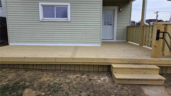 a view of outdoor space with wooden floor and fence