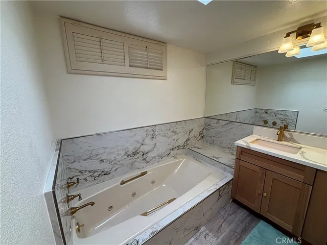 a bathroom with a bathtub and sink