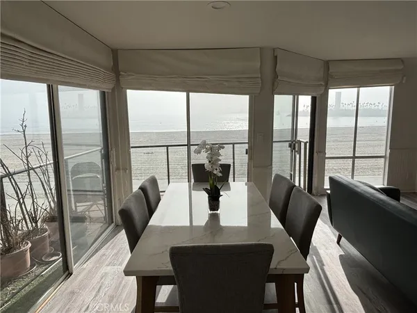 a view of a dining room with furniture window and wooden floor