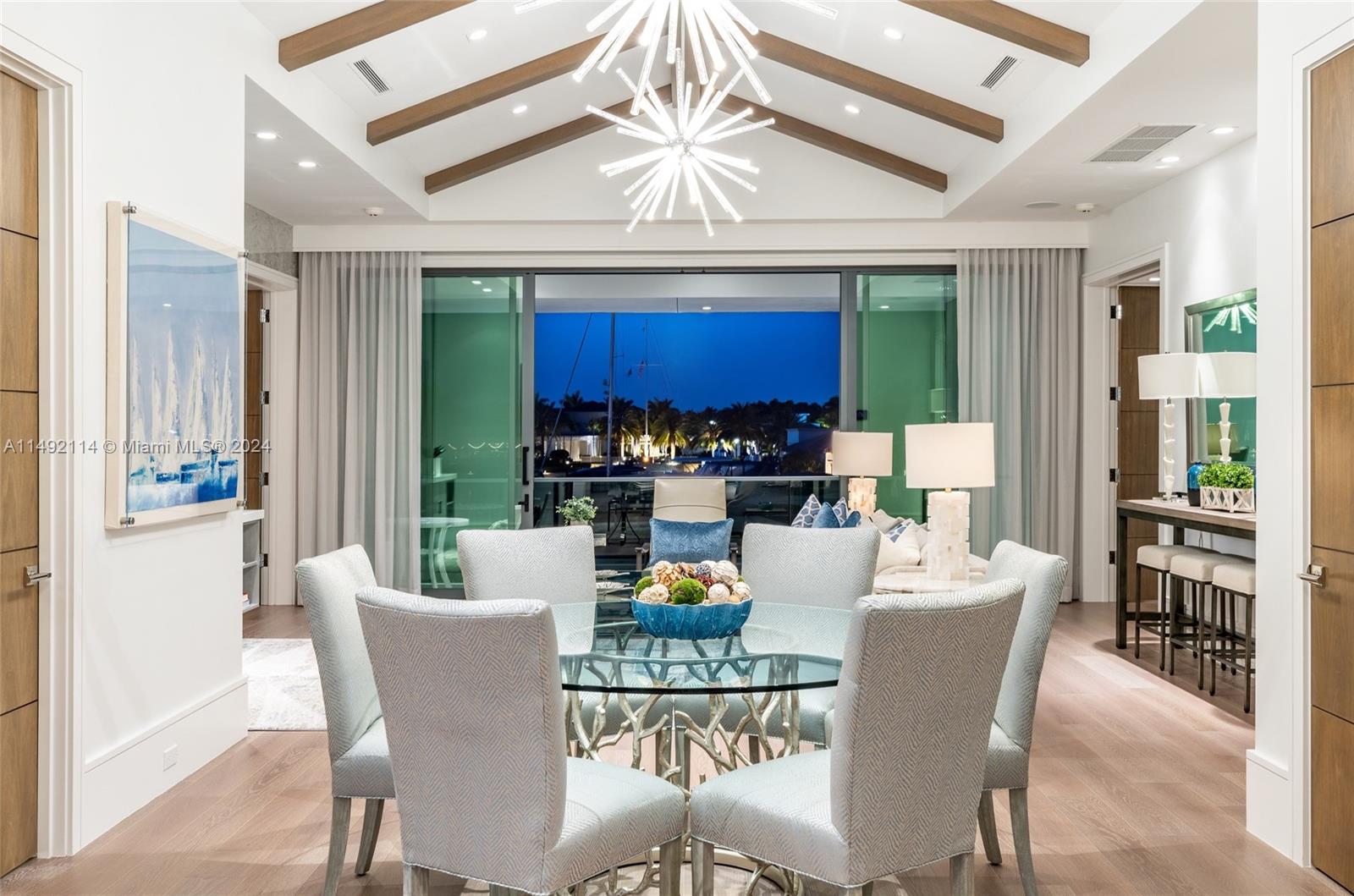 169 West Key Palm Road Boca Raton, FL 33432 - Photo 18 of 27 a dining room with furniture a kitchen view and a chandelier