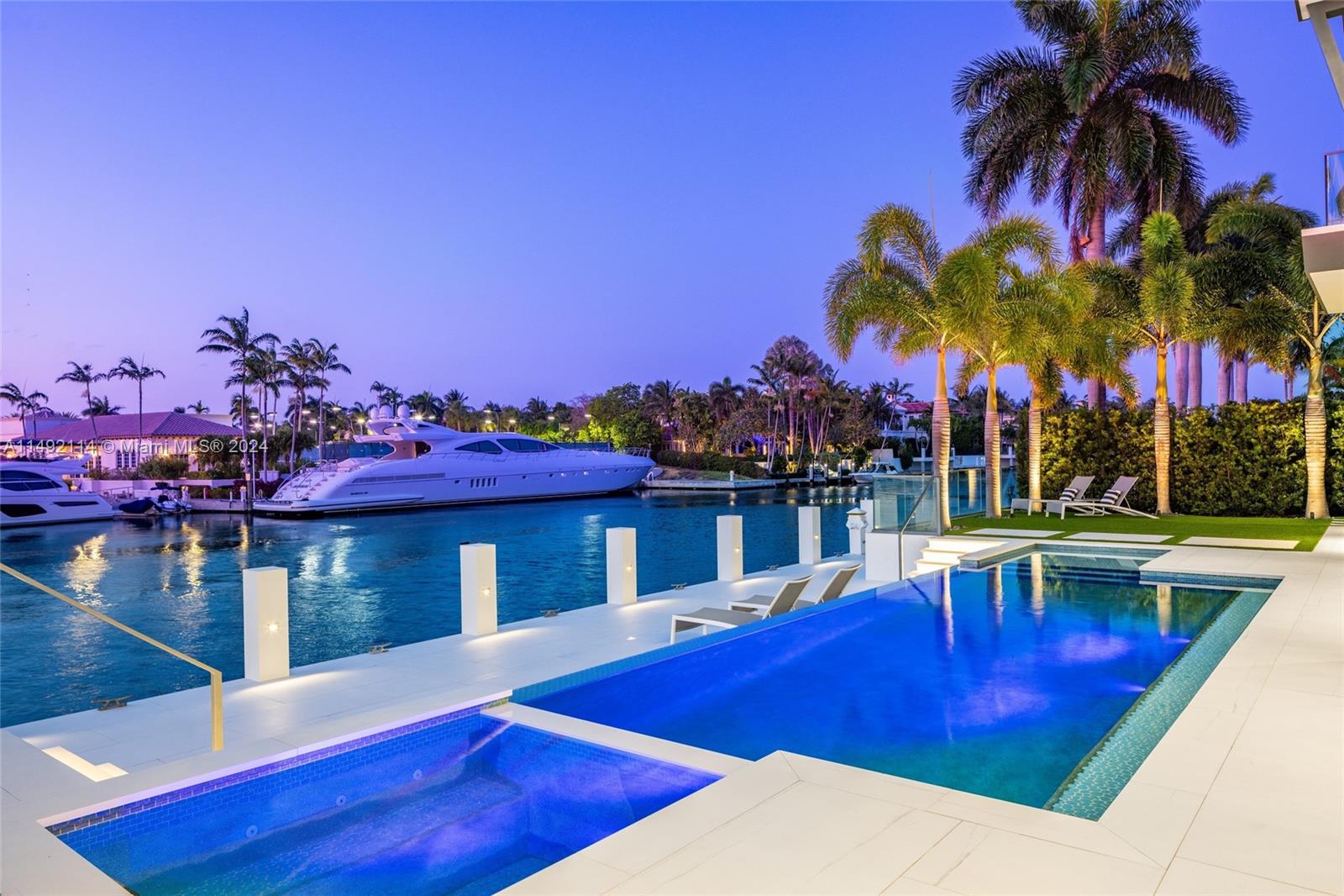169 West Key Palm Road Boca Raton, FL 33432 - Photo 24 of 27 a view of a swimming pool with a table and chairs