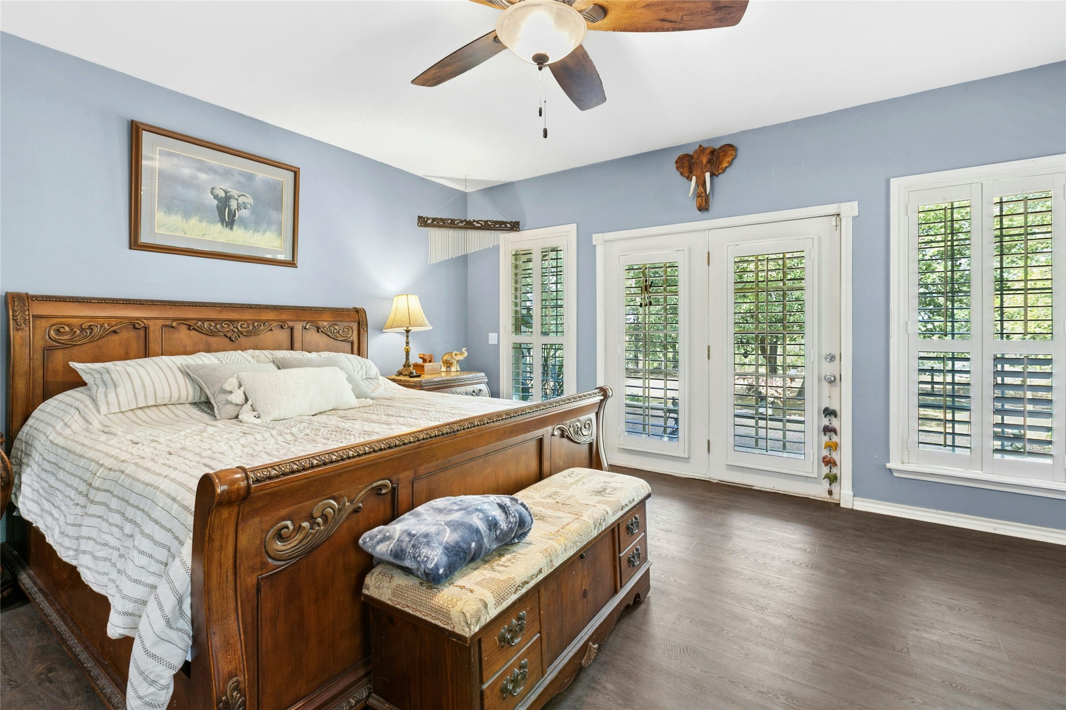 412 Woody Hollow Road Luling, TX 78648 - Photo 14 of 33 Bedroom featuring access to exterior, ceiling fan, and dark wood-type flooring