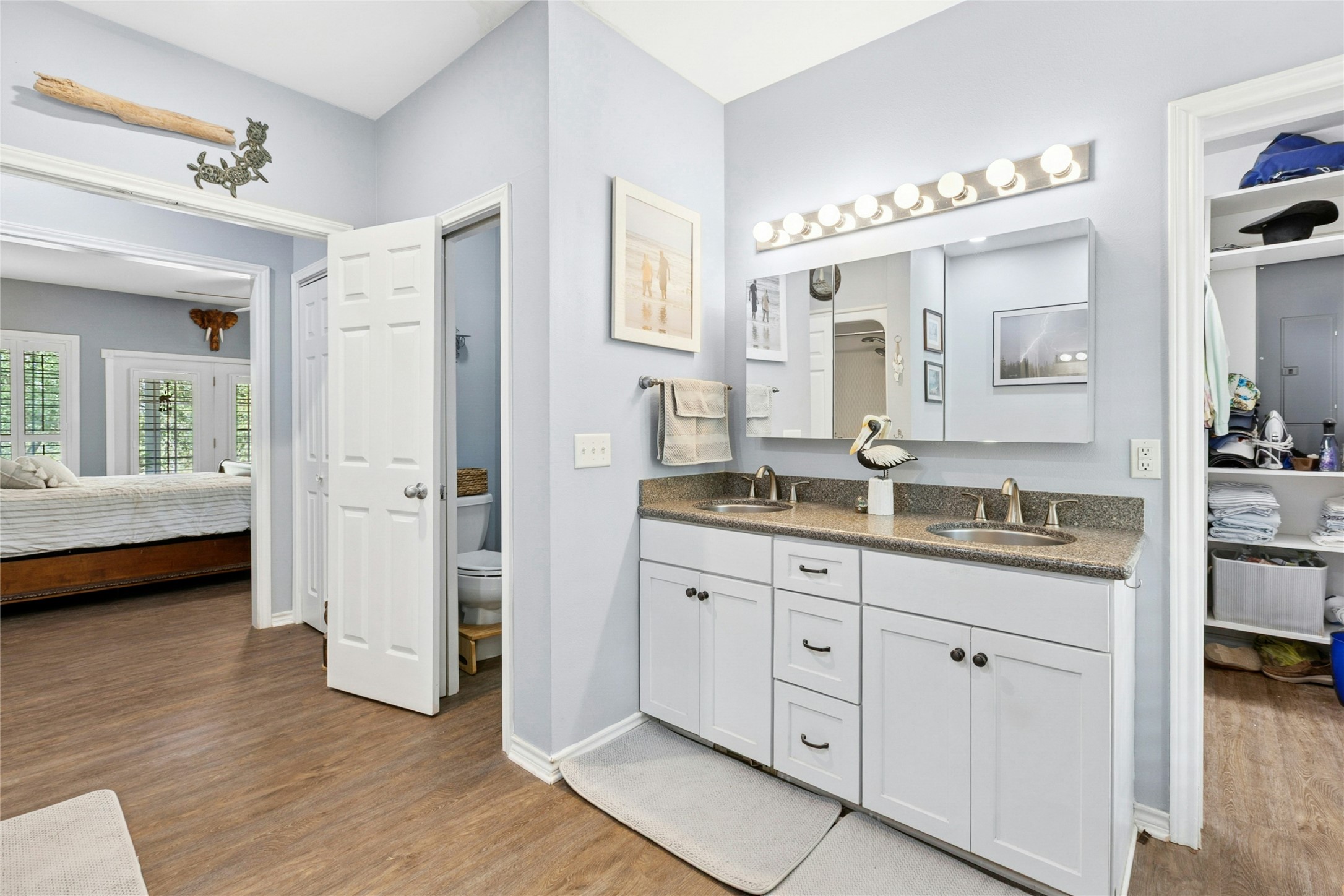 412 Woody Hollow Road Luling, TX 78648 - Photo 16 of 33 Ensuite bathroom featuring double vanity and wood finished floors