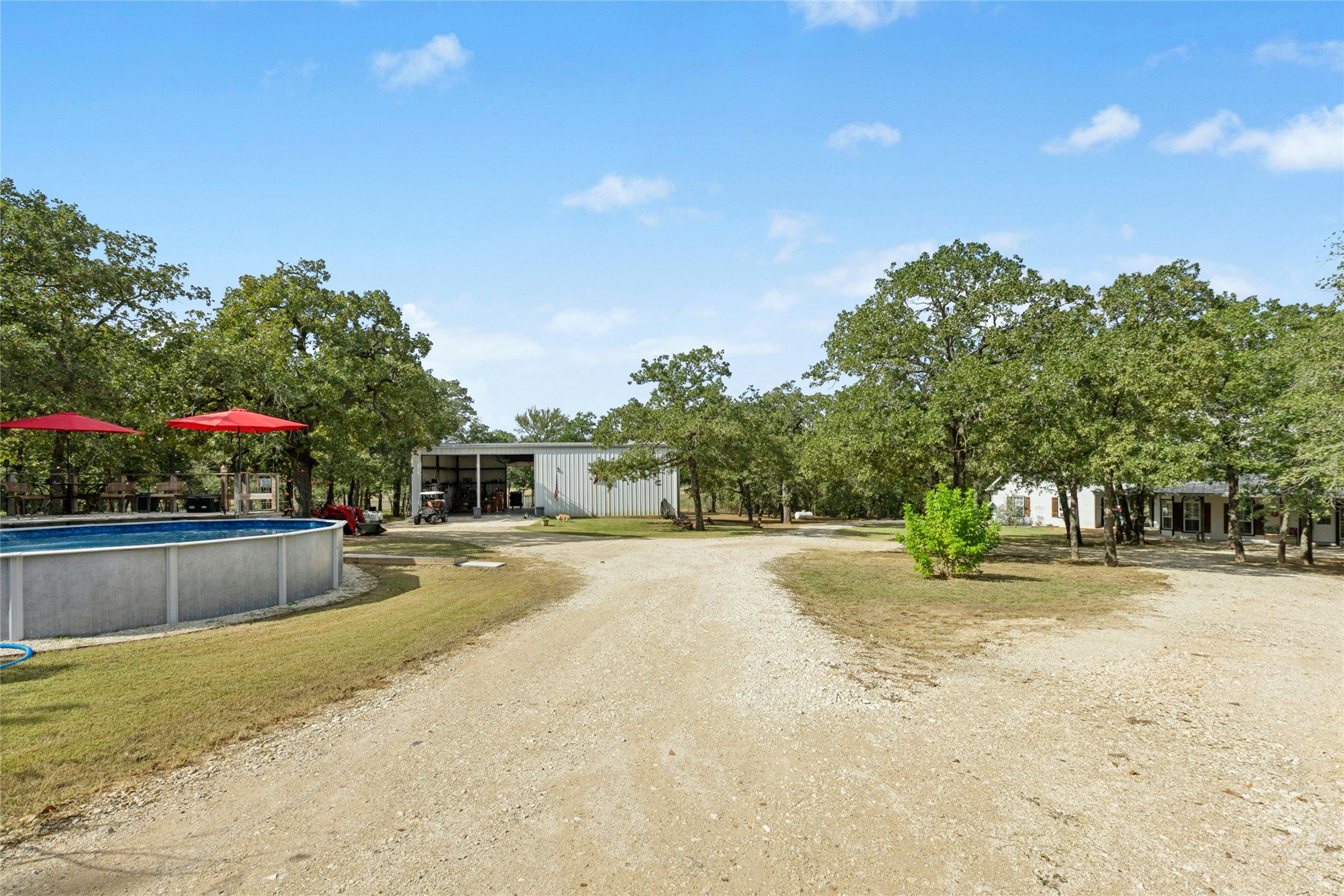 412 Woody Hollow Road Luling, TX 78648 - Photo 25 of 33 View of pool, shop, and home