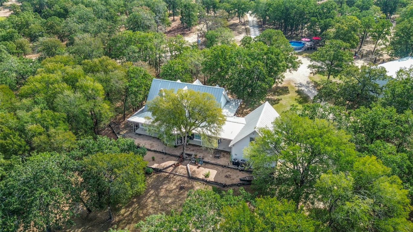 412 Woody Hollow Road Luling, TX 78648 - Photo 35 of 39 an aerial view of a house with a yard and large trees