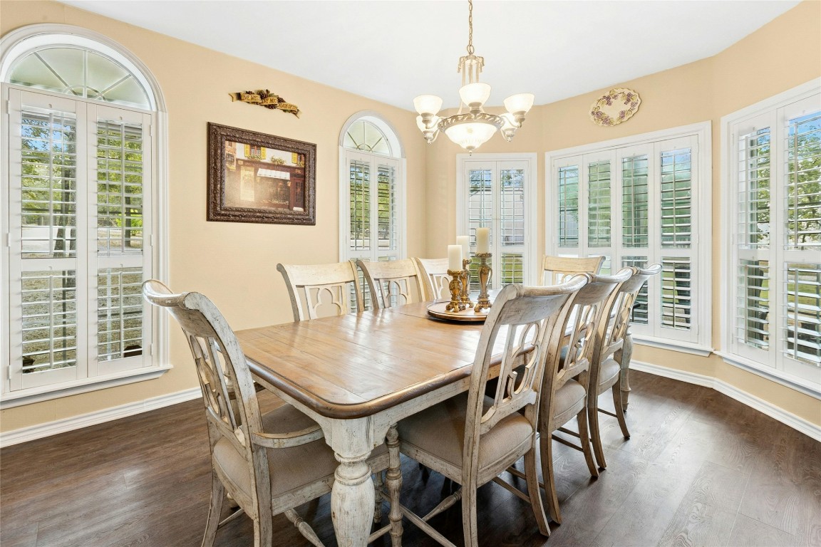 412 Woody Hollow Road Luling, TX 78648 - Photo 8 of 39 a view of a dining room with furniture wooden floor and chandelier