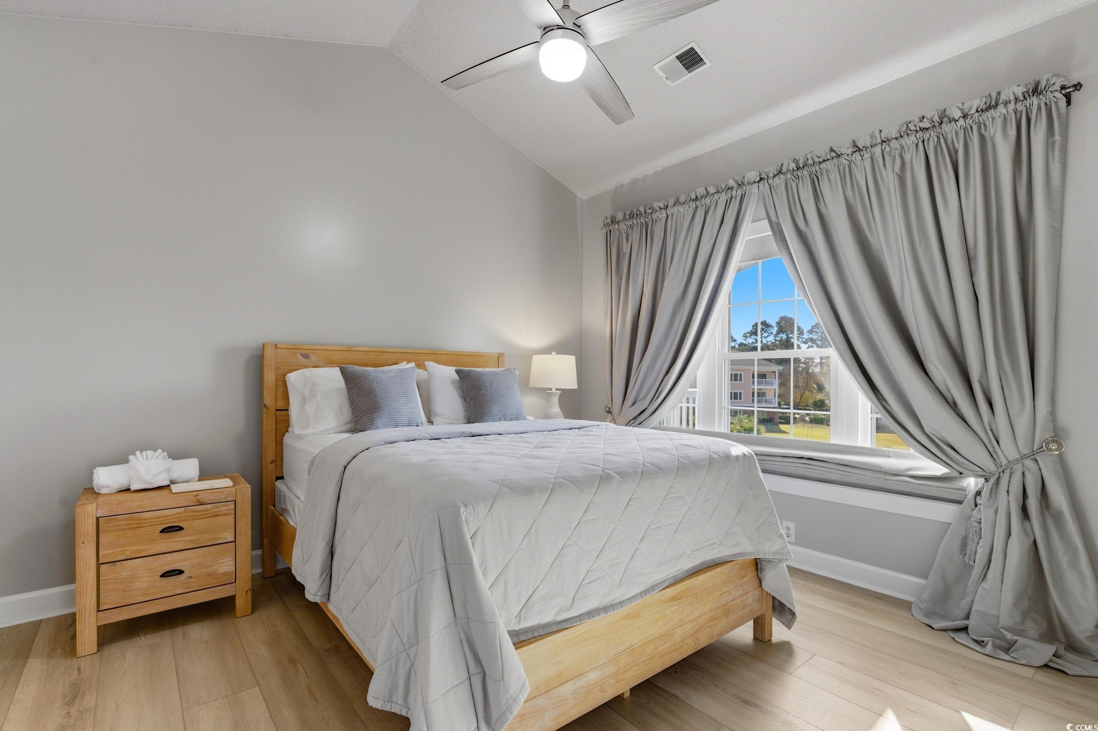 4839 Carnation Circle, Unit 305 Myrtle Beach, SC 29577 - Photo 11 of 24 Bedroom featuring vaulted ceiling, light wood finished floors, and ceiling fan