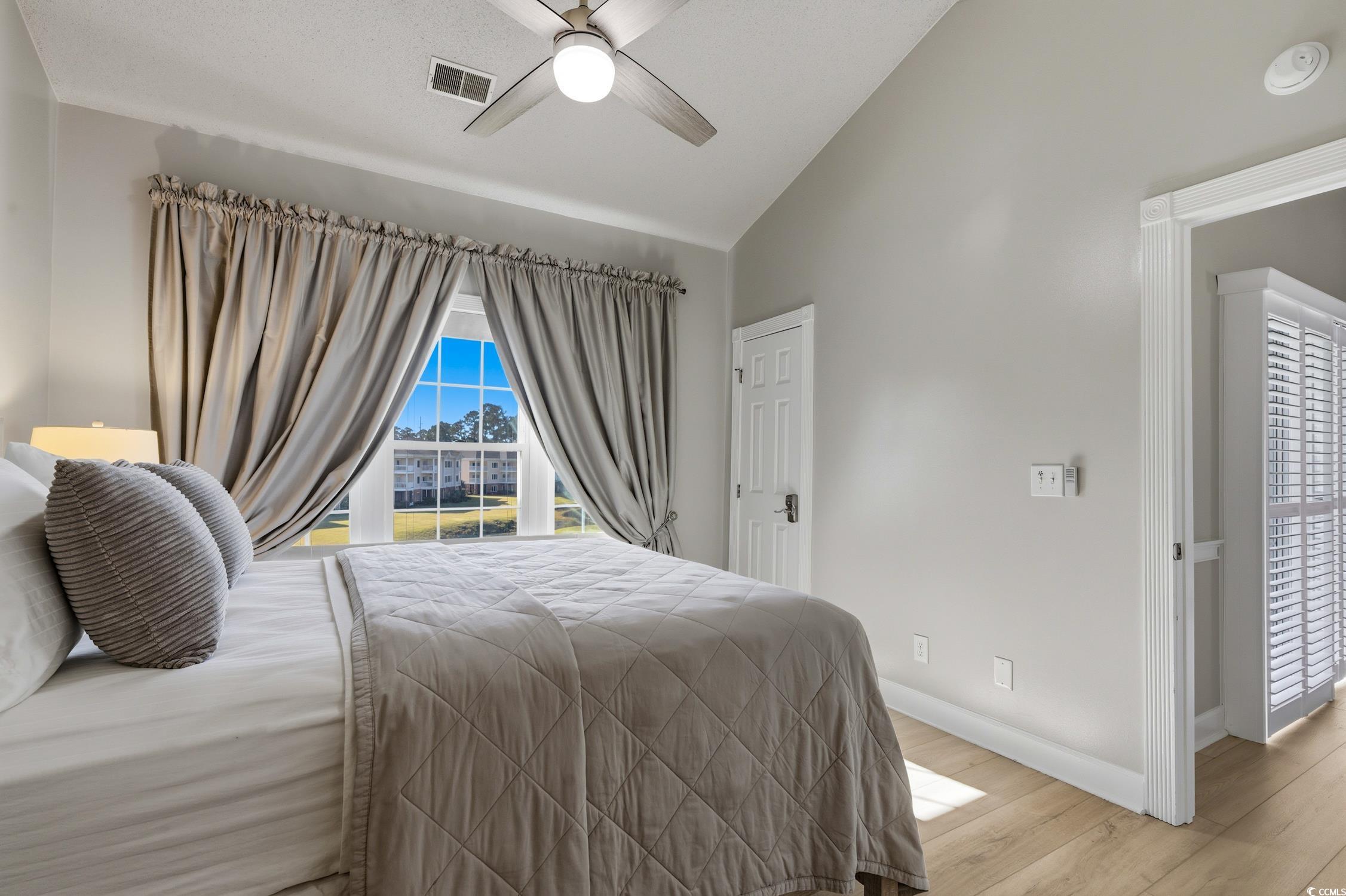 4839 Carnation Circle, Unit 305 Myrtle Beach, SC 29577 - Photo 12 of 24 Bedroom featuring wood finished floors, vaulted ceiling, and a ceiling fan