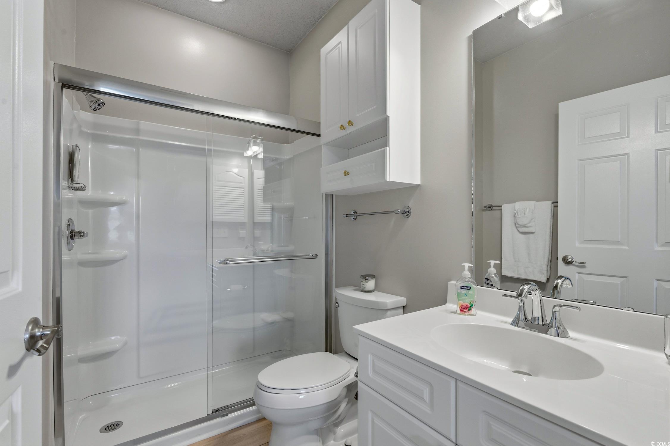 4839 Carnation Circle, Unit 305 Myrtle Beach, SC 29577 - Photo 13 of 24 Bathroom featuring a shower stall and vanity