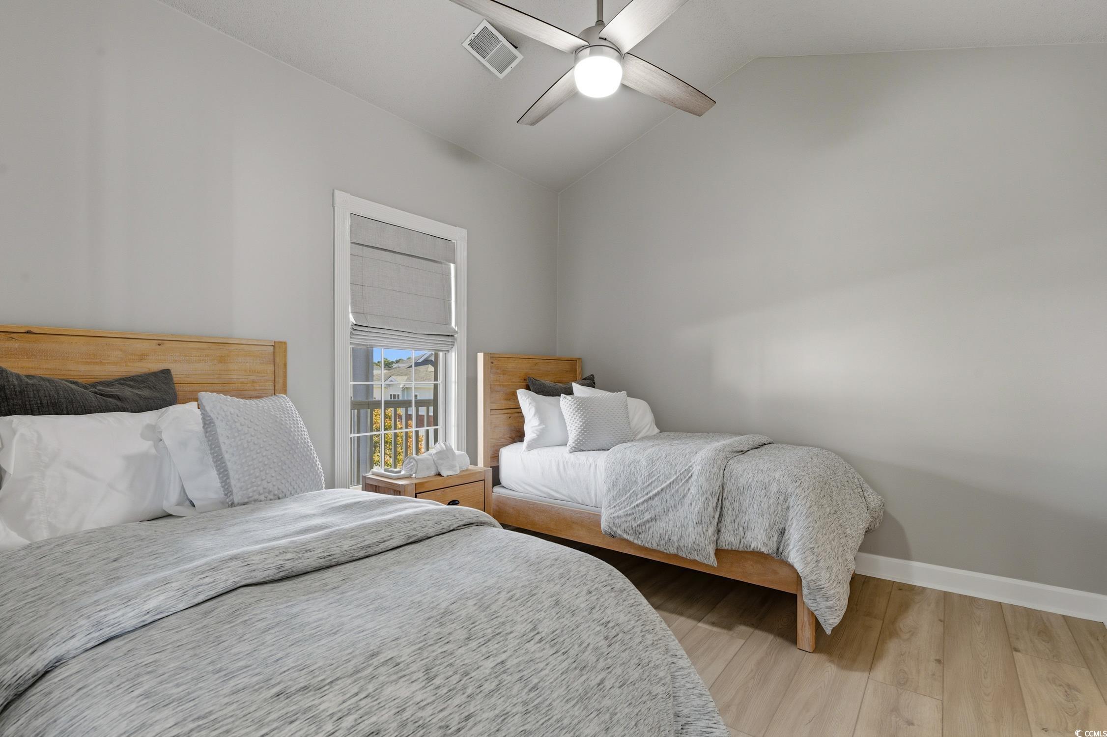 4839 Carnation Circle, Unit 305 Myrtle Beach, SC 29577 - Photo 14 of 24 Bedroom with wood finished floors, lofted ceiling, and a ceiling fan