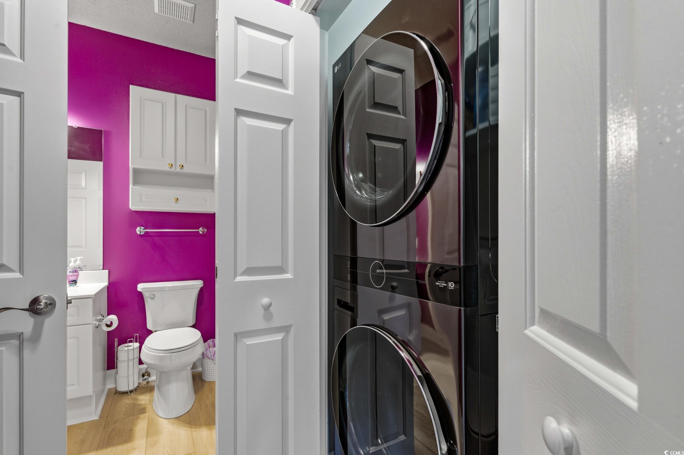 4839 Carnation Circle, Unit 305 Myrtle Beach, SC 29577 - Photo 16 of 24 Washroom featuring light wood-style floors and stacked washer and clothes dryer