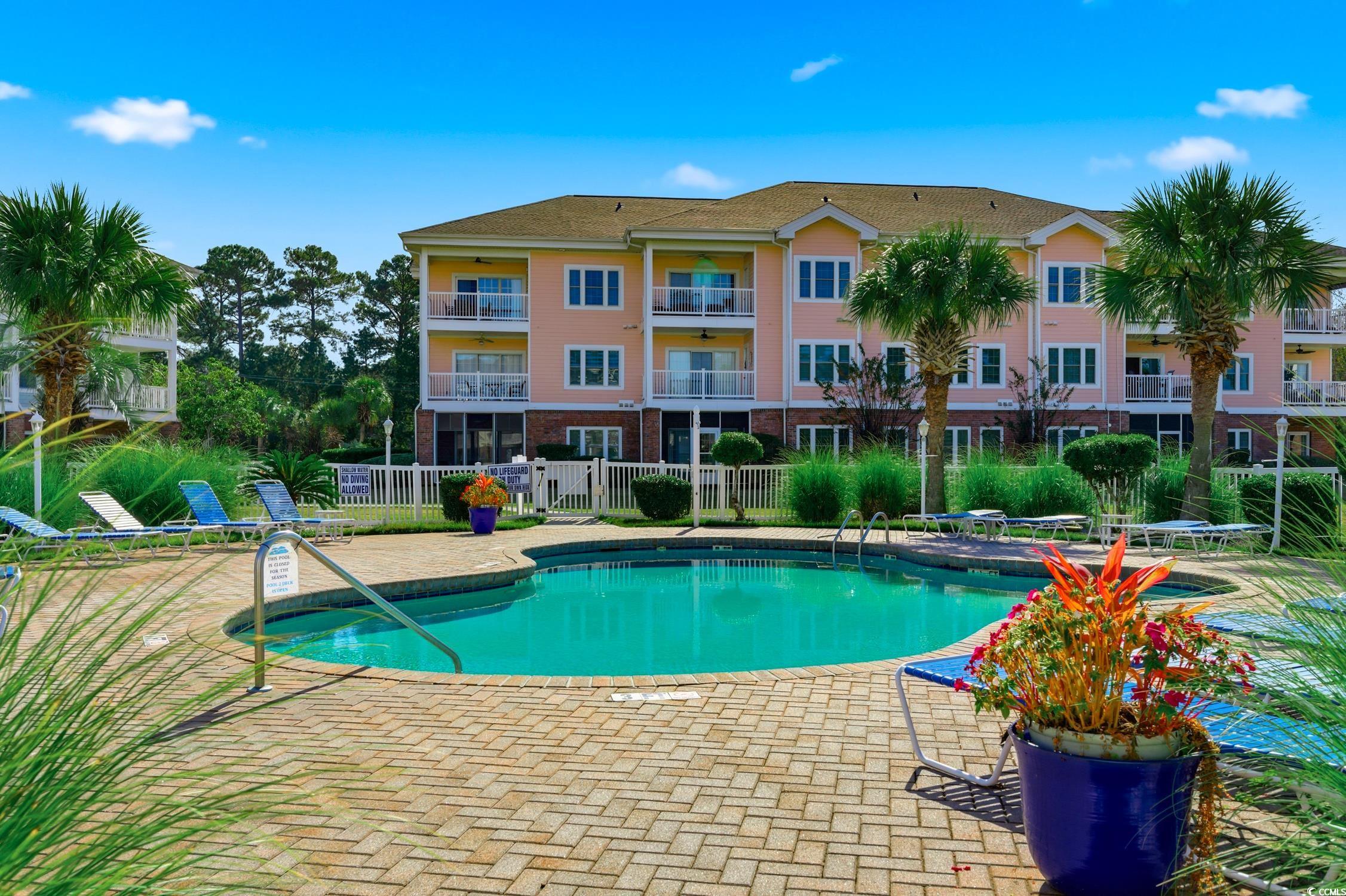 4839 Carnation Circle, Unit 305 Myrtle Beach, SC 29577 - Photo 23 of 24 Community pool featuring a patio