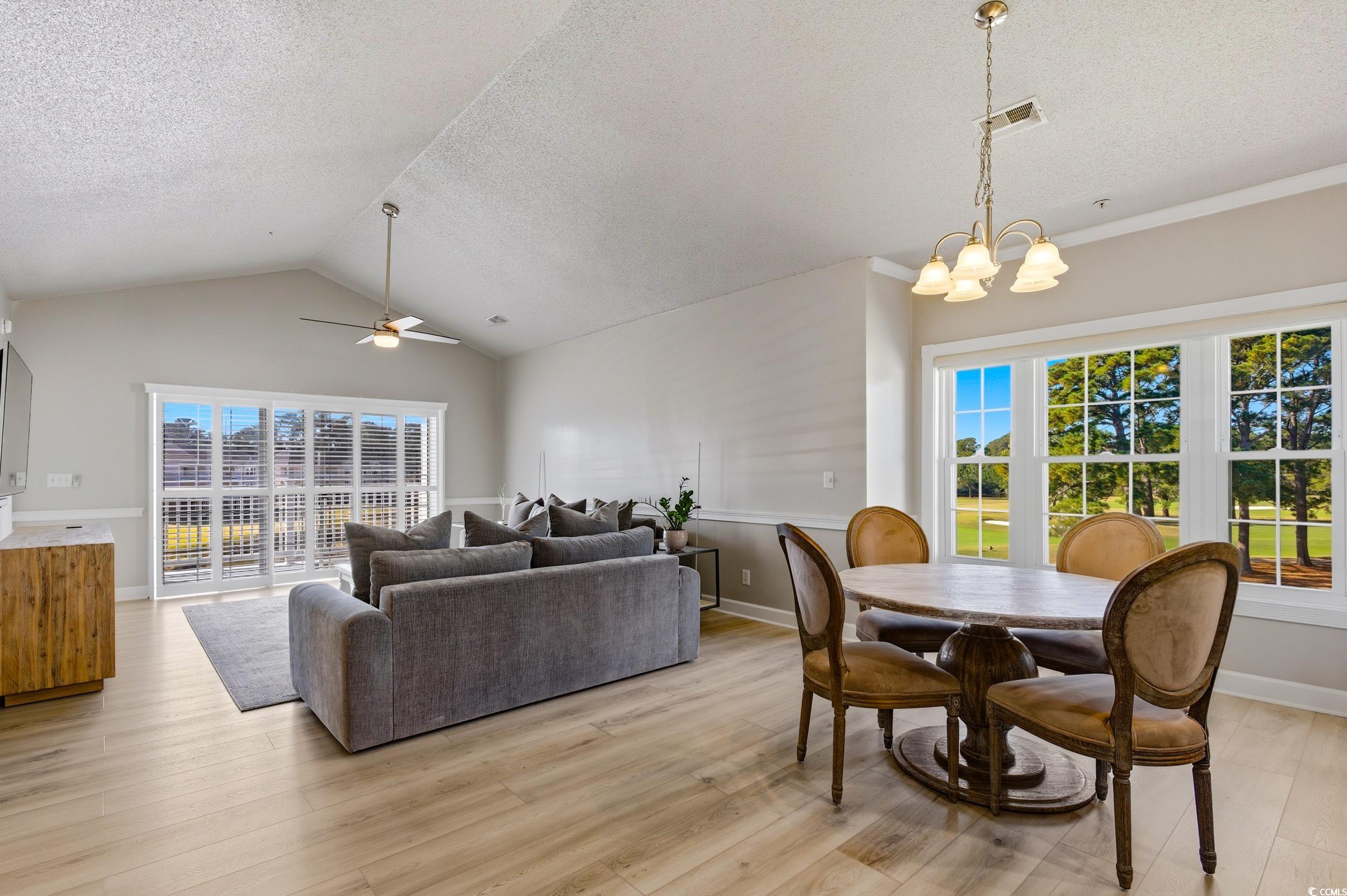 4839 Carnation Circle, Unit 305 Myrtle Beach, SC 29577 - Photo 5 of 24 Dining space with lofted ceiling, light wood-style floors, a textured ceiling, and ceiling fan