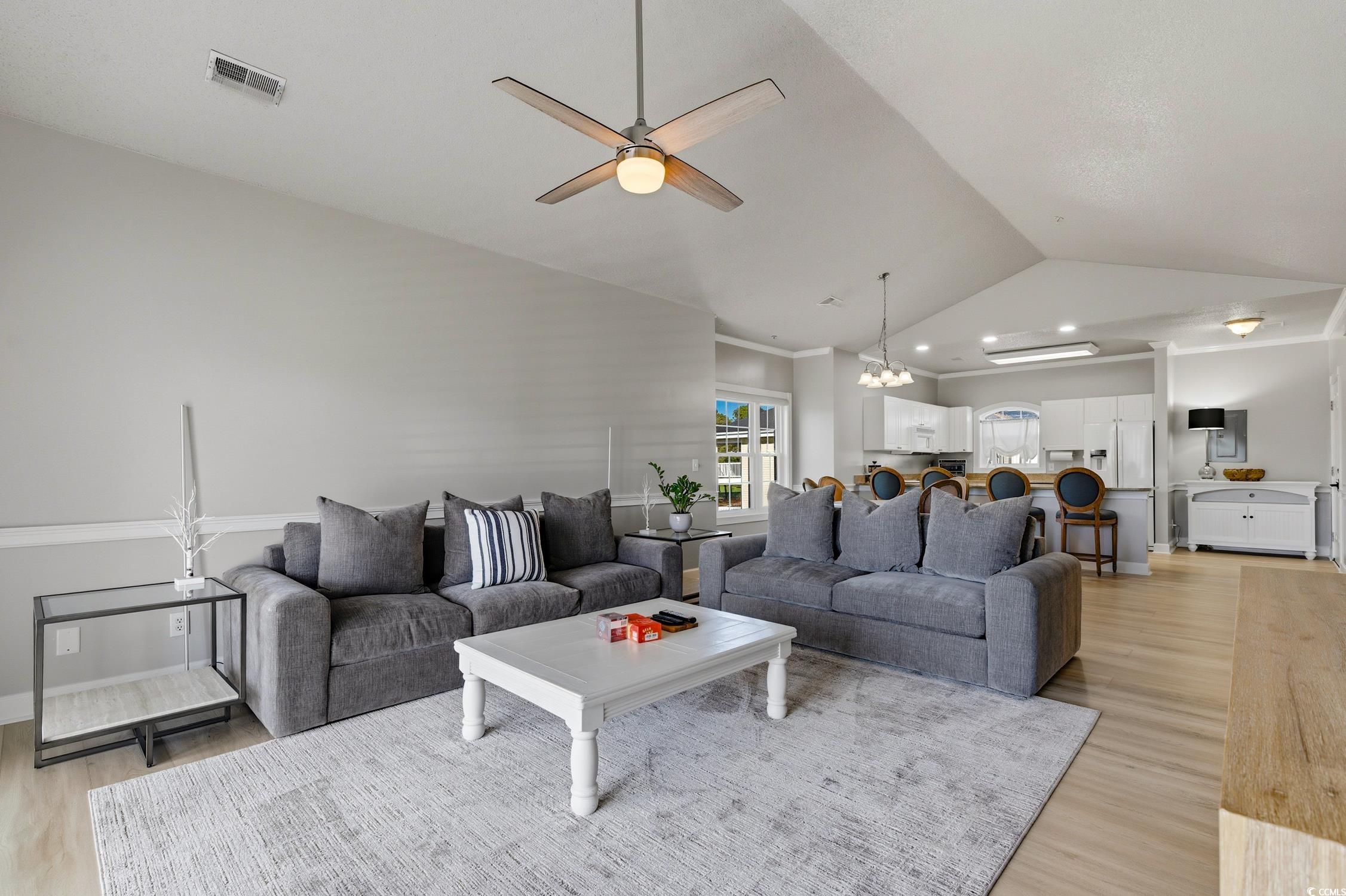 4839 Carnation Circle, Unit 305 Myrtle Beach, SC 29577 - Photo 10 of 24 Living area with light wood finished floors, lofted ceiling, a chandelier, and a ceiling fan